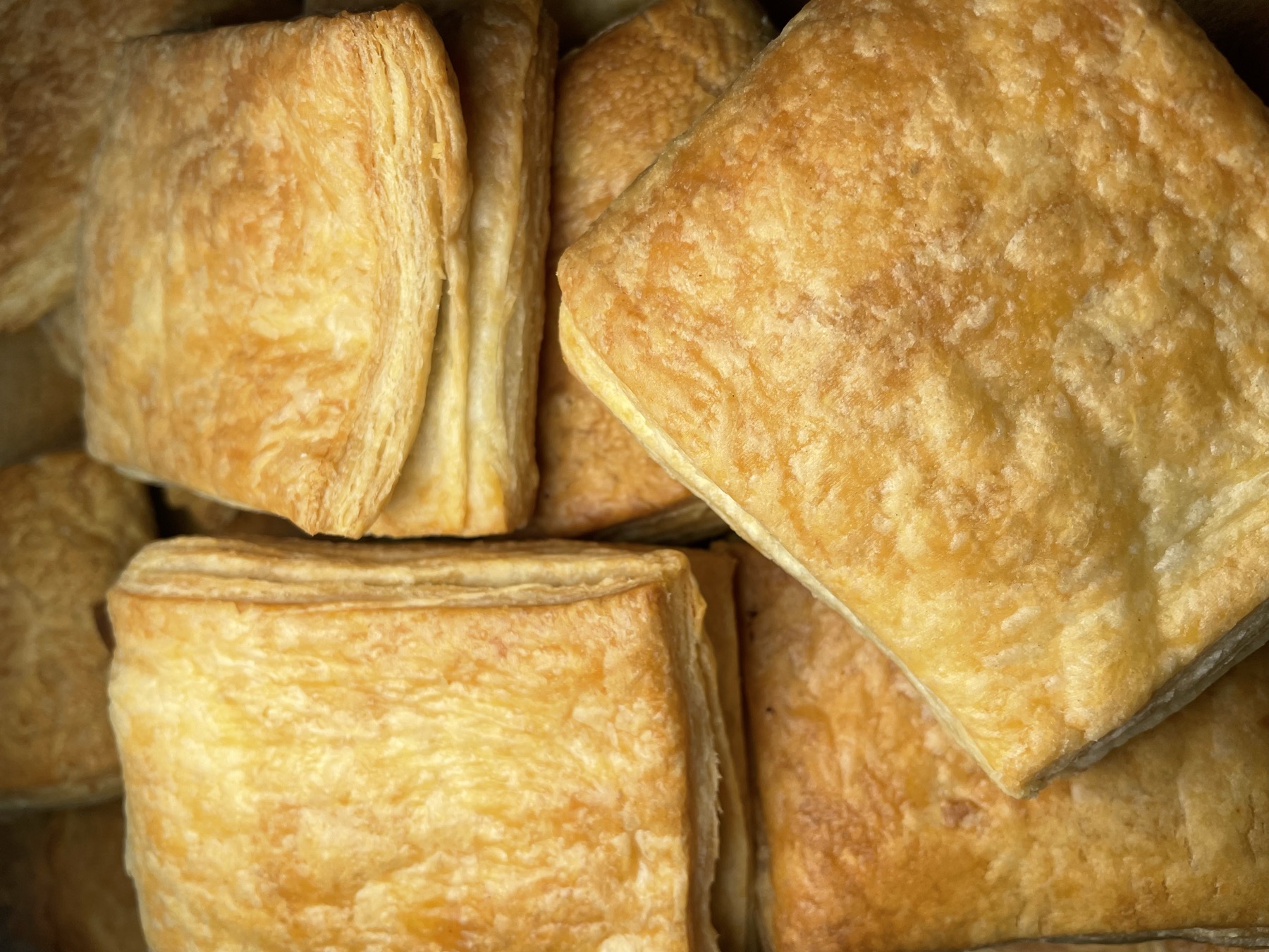 Freshly baked golden Haitian patties